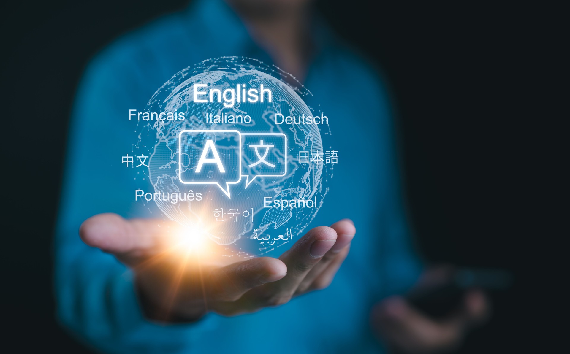 Multilingual Language Translation Technology Concept. A person holding holographic globe with speech bubbles and various languages, represents global language translate and multilingual communication.
